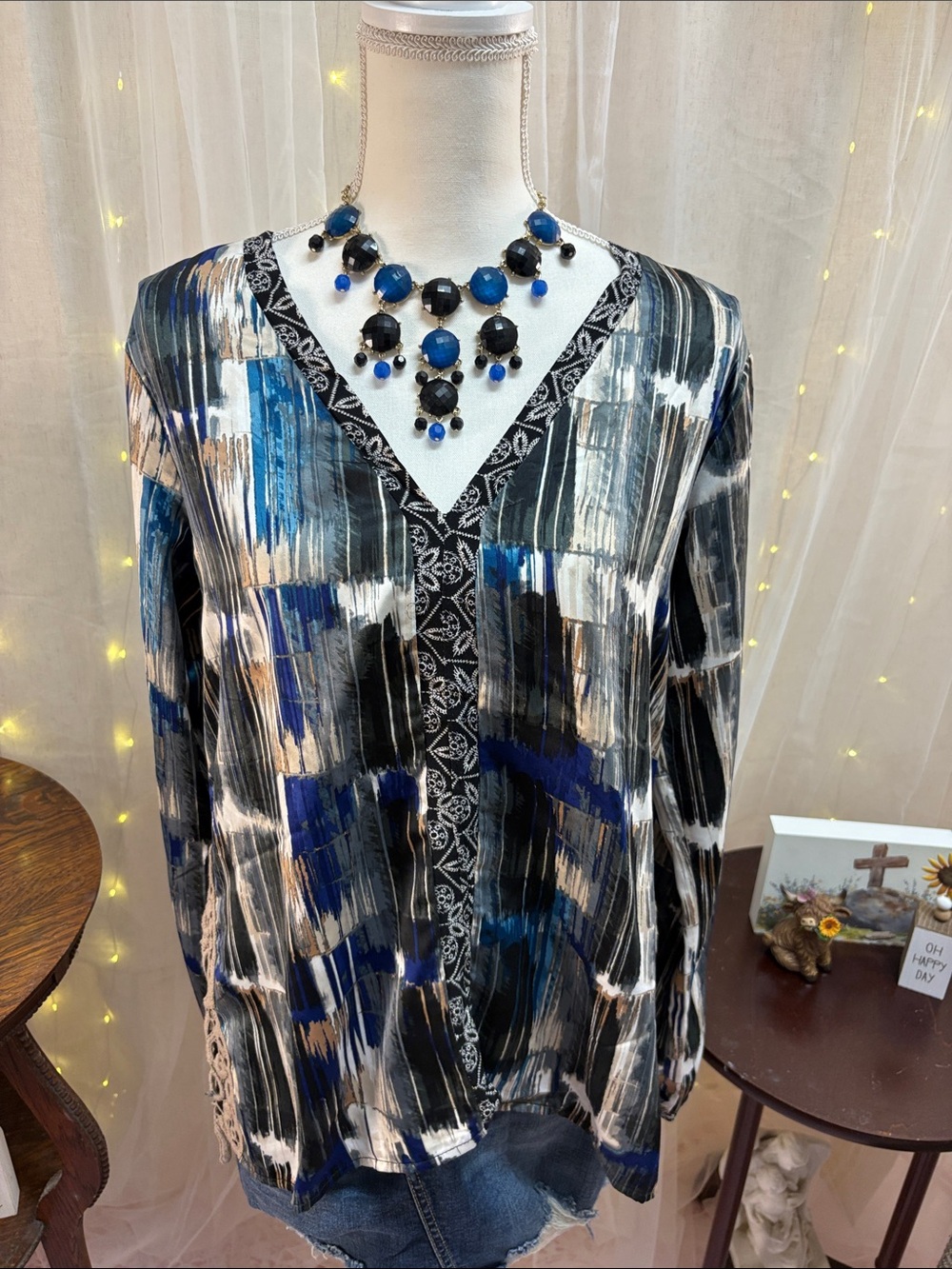 Women’s blouse. Fun patter in black, blue, cream, tan, and grey.